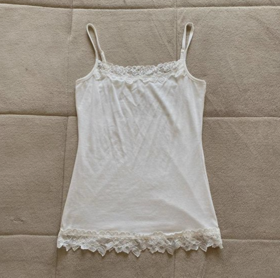 White lace-trimmed camisole on a quilted background