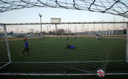 Boys from the RCD Espanyol soccer academy practice during a training session at Dani Jarque training camp in Sant Adria de Besos, near Barcelona, Spain February 20, 2017. REUTERS/ Albert Gea/Files