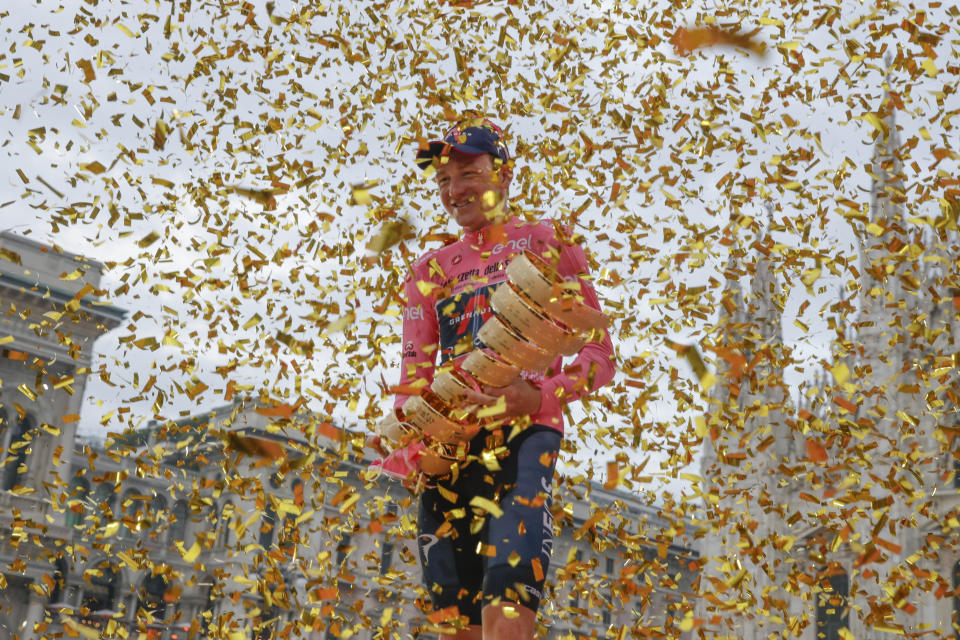 Britain's Tao Geoghegan Hart holds the trophy after winning the Giro d'Italia cycling race, in Milan, Italy, Sunday, Oct. 25, 2020. In one of the most exciting final stages of a Grand Tour, British rider Tao Geoghegan Hart won the Giro d’Italia on Sunday, edging out Australian Jai Hindley by just 39 seconds. (AP Photo/Luca Bruno)