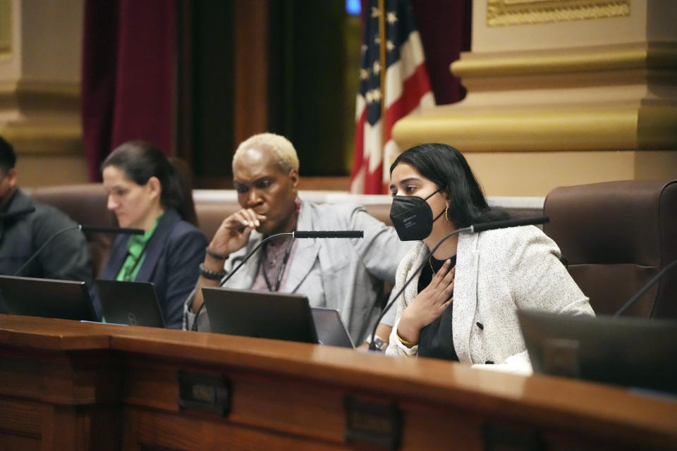 Minneapolis City Council member Aisha Chughtai, right, speaks prior to the Minneapolis City Council voting 11-0 to approve an agreement that would provide sweeping new rules for how the Police Department investigates crimes, conducts searches and holds problem officers accountable, Friday, March 31, 2023 at City Hall in Minneapolis, Minn. To her left is Minneapolis city council president Andrea Jenkins and council member Linea Palmisano. (David Joles/Star Tribune via AP)