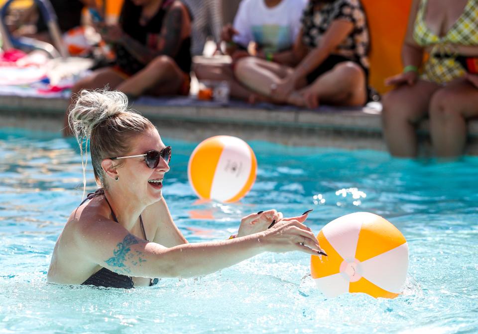 Jennifer Bush of Michigan laughs while playing with beach balls with friends during the L Word Pool Party of The Dinah at the Hilton Hotel, Saturday, Oct. 2, 2021, in Palm Springs, Calif. 