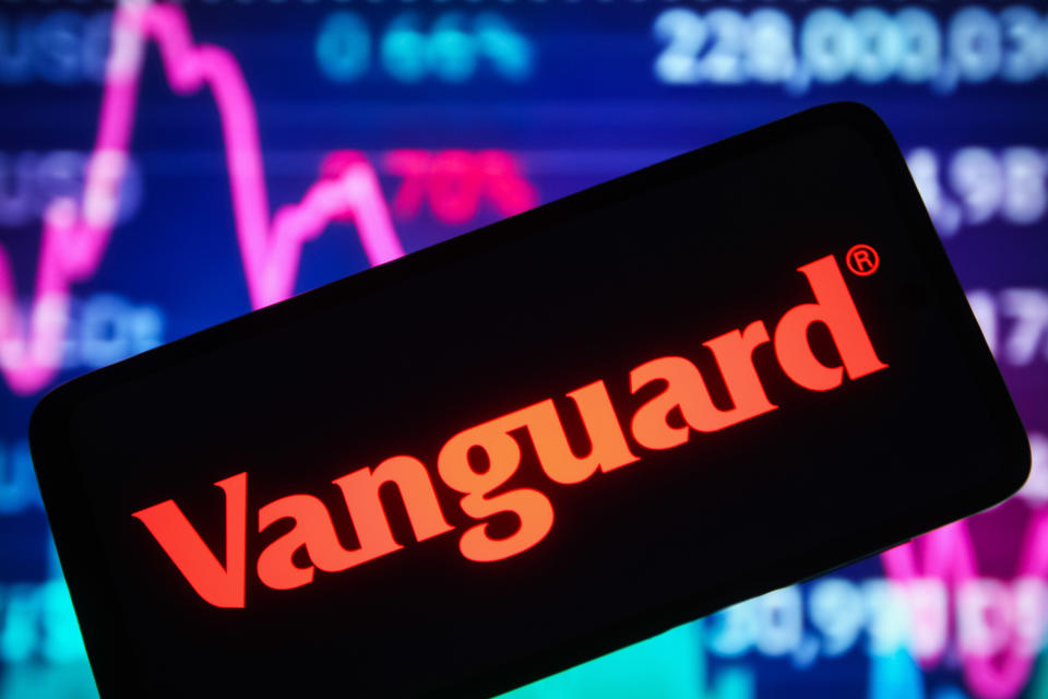 UKRAINE - 30/12/2021: In this photo illustration the logo of Vanguard Group Inc. is shown.  displayed on a smartphone screen and a line graph of the stock market can be seen in the background.  (Photo illustration by Pavlo Gonchar/SOPA Images/LightRocket via Getty Images)