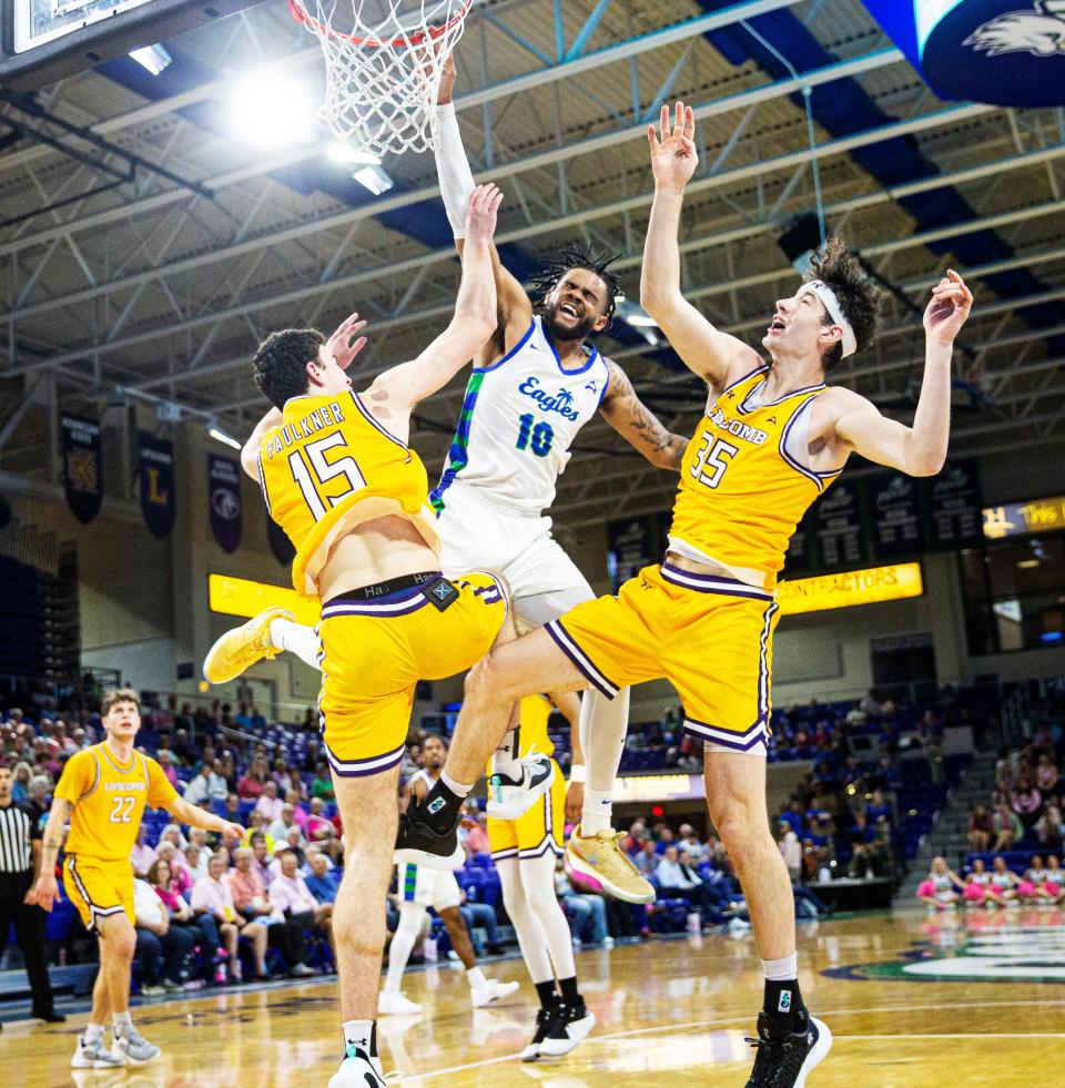 Zach Anderson of the FGCU Men's basketball team gets fouled as he drives to the basket during game against Lipscomb at Alico Arena on Thursday, Jan. 25, 2024.