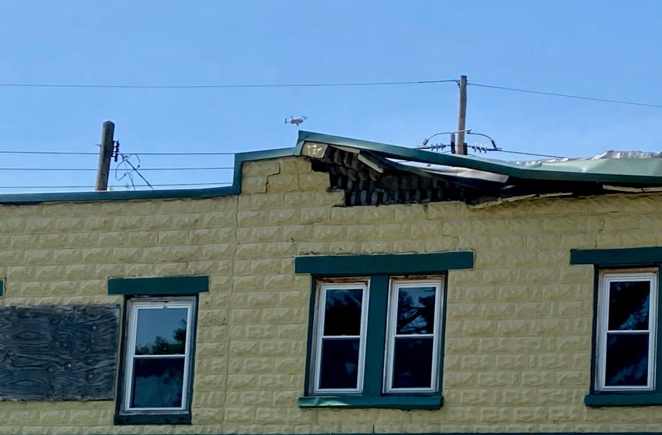 A drone is seen just above the roof line of the former Startzman's Hardware store on Sunday after part of the facade collapsed onto the sidewalk and South Potomac Street. Hagerstown firefighters were on the scene.