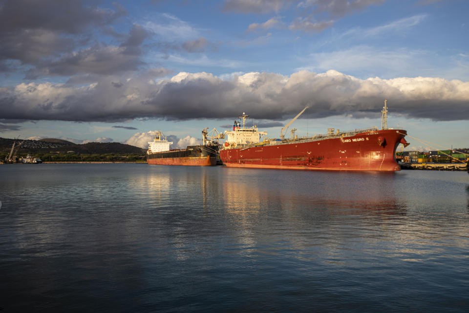 A coal barge and oil ship are docked in Honolulu after the state received its last shipment of coal, Thursday, July 28, 2022. (Hawaii State Energy Office via AP)