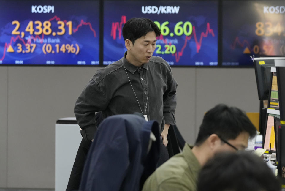 A currency trader watches monitors near the screens showing the Korea Composite Stock Price Index (KOSPI), left, and the foreign exchange rate between U.S. dollar and South Korean won, center, at the foreign exchange dealing room of the KEB Hana Bank headquarters in Seoul, South Korea, Wednesday, March 29, 2023. Asian stocks were mixed Wednesday as anxiety about the global financial system began to fade following three high-profile bank failures.(AP Photo/Ahn Young-joon)
