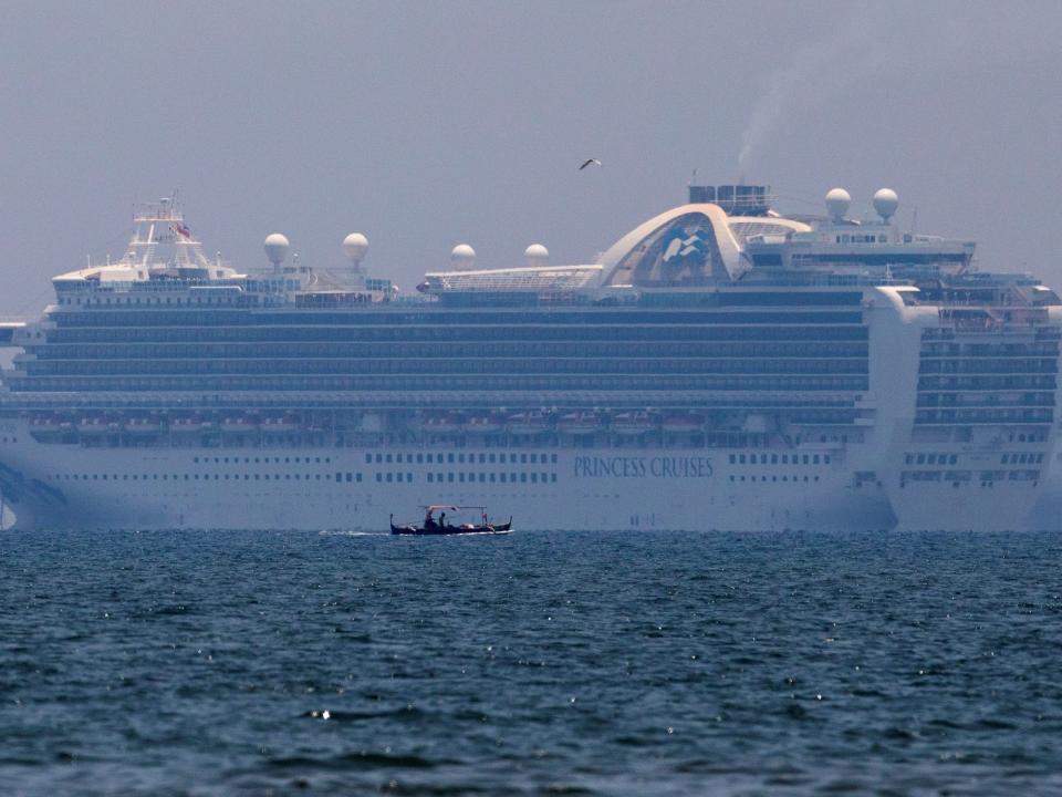 A fishing boat sails past the Princess Cruises' Ruby Princess cruise ship as it docks in Manila Bay during the spread of the coronavirus disease (COVID-19), in Cavite city, Philippines, May 7, 2020. REUTERS/Eloisa Lopez