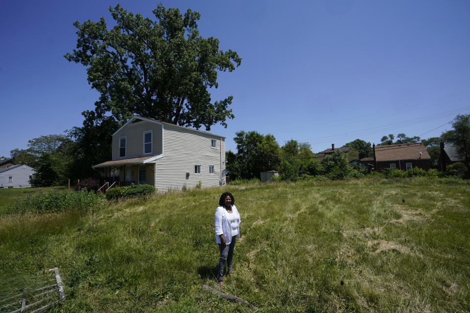 Donele Wilkins, founder of Green Door Initiative, a group that does environmental workforce development, stands in the field next to her childhood home where her company is developing a solar community hub, Tuesday, June 28, 2022, in Detroit. Fourteen smaller environmental justice organizations from around the United States, including Green Door Initiative, have begun to receive money under the Justice40 initiative to improve the environment in disadvantaged communities and help them prepare for climate change. (AP Photo/Carlos Osorio)