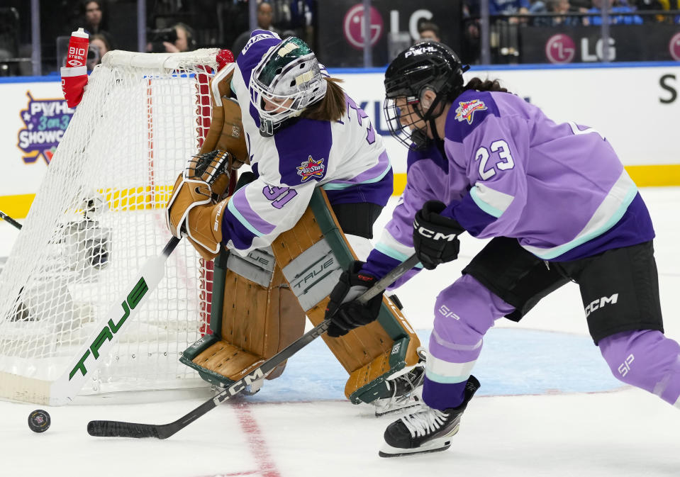 Team King goalie Aerin Frankel (31) clears the puck away from Team Kloss' Erin Ambrose (23) during the PWHL 3-on-3 Showcase at the NHL All-Star hockey week in Toronto on Thursday, Feb. 1, 2024. (Frank Gunn/The Canadian Press via AP)
