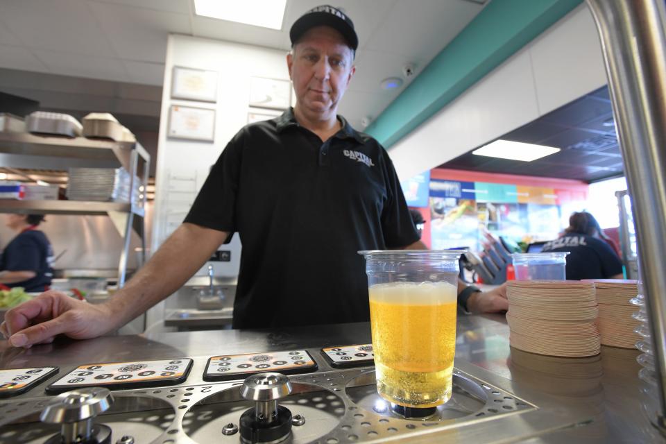 Capital Tacos franchise co-owner James Muller watches as the bottom filling draft beer dispenser system precisely fills a cup of beer at the newly opened Tex-Mex restaurant at 12220 Atlantic Blvd. in Atlantic-Kernan Shops shopping center in Jacksonville.