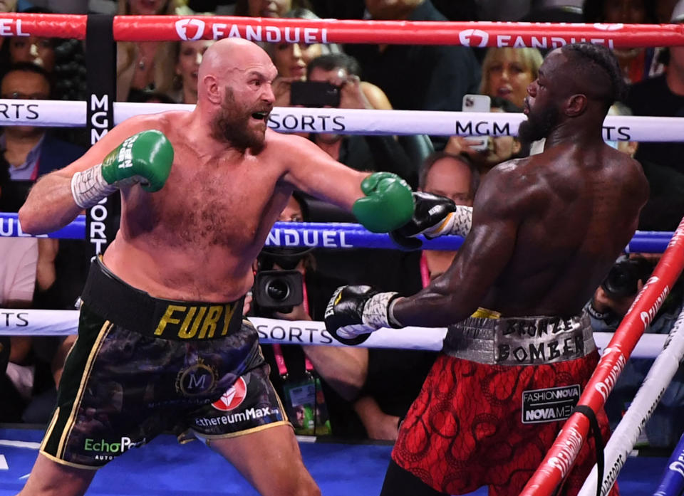 Seen here, Tyson Fury shapes up to hit Deontay Wilder in the seventh round of their WBC heavyweight trilogy fight.