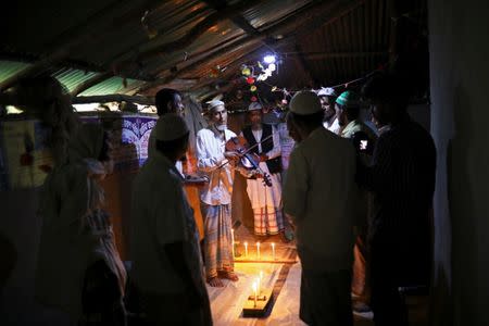 Amir Ali, a Rohingya violinist who was a member of a wedding band of the northern Rakhine State of Myanmar, plays the violin during a weekly prayer event at the Kutupalong refugee camp in Cox's Bazar, Bangladesh, March 7, 2019. REUTERS/Mohammad Ponir Hossain