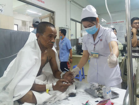 A victim of a fire that broke out in an apartment, receives treatment at a hospital in Ho Chi Minh City, Vietnam March 23, 2018. VNA/Dinh Hang via REUTERS