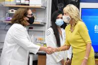 Dr. Nancy Klauber-DeMore, a breast surgical oncologist at MUSC Hollings Cancer Center, left, greets first lady Jill Biden during a presentation on tumor research on Monday, Oct. 25, 2021, in Charleston, S.C. (AP Photo/Meg Kinnard)