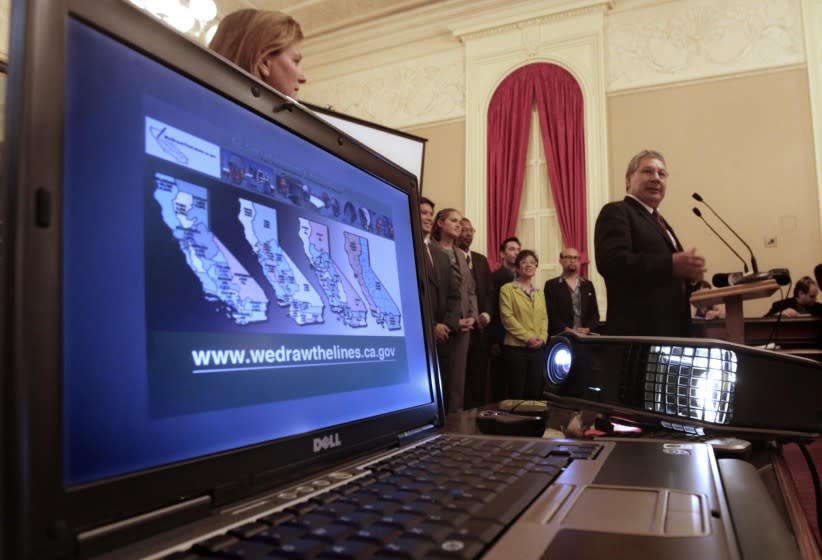 Gabino Aguirre, right, of the California Citizens Redistricting Commission discusses redistricting maps at a Sacramento news conference in 2011.