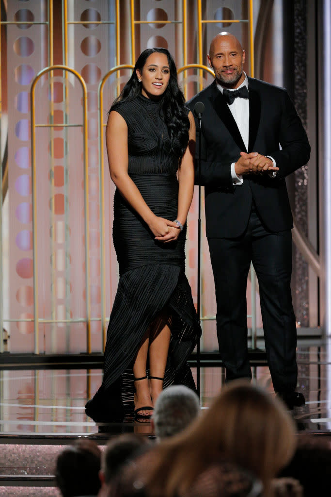 Golden Globe Ambassador Simone Garcia Johnson and her popular dad, Dwayne “The Rock” Johnson, speak onstage during the Golden Globes. (Photo: Paul Drinkwater/NBCUniversal via Getty Images)