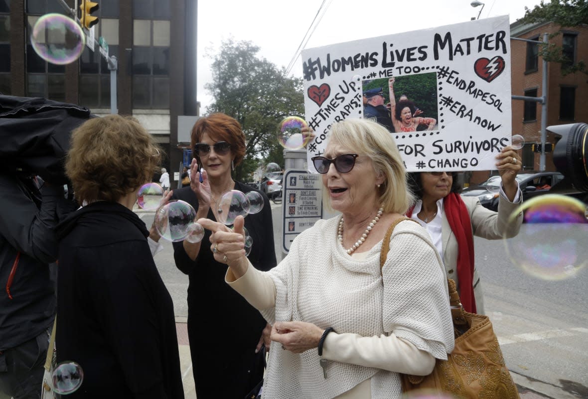 Victoria Valentino, center, appears with a protester near the Montgomery County Courthouse on Sept. 24, 2018, in Norristown, Pa. (AP Photo/Jacqueline Larma, File)