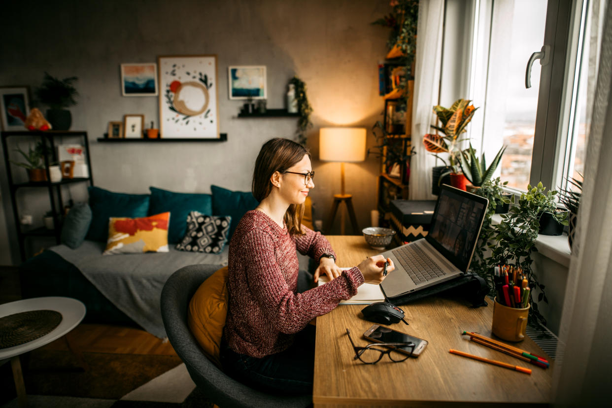 Young woman working from home office and having video conference.