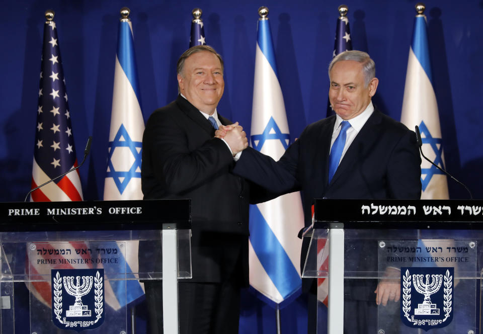 U.S. Secretary of State Mike Pompeo, left, shakes hands with Israeli Prime Minister Benjamin Netanyahu, during their visit to Netanyahu's official residence in Jerusalem, Thursday March 21, 2019. Netanyahu has praised U.S. President Donald Trump's recognition of its control over the Golan Heights as a holiday "miracle." (Amir Cohen/Pool via AP)