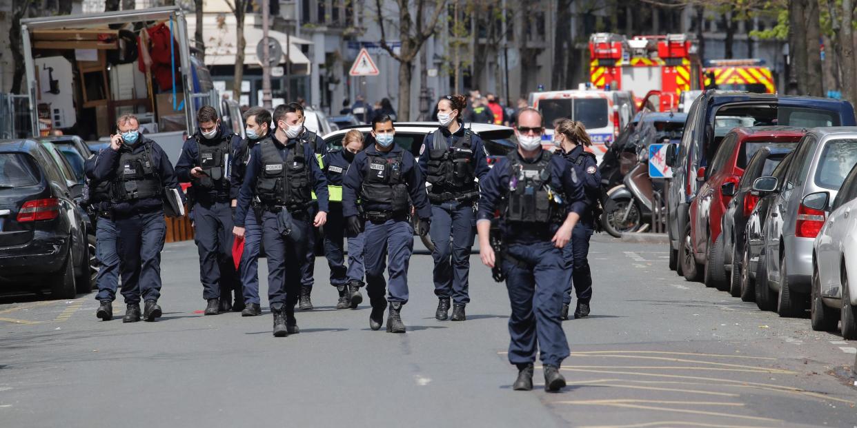 Police officers leave the scene after a shooting Monday, April 12, 2021 in Paris. A gunman has shot two people in front of a hospital in Paris and the attacker fled on a motorcycle.