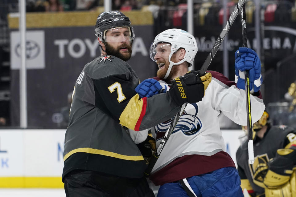 Colorado Avalanche left wing Gabriel Landeskog, right, celebrates after teammate Colorado Avalanche right wing Mikko Rantanen, not pictured, scored against the Vegas Golden Knights the during the third period in Game 3 of an NHL hockey Stanley Cup second-round playoff series Friday, June 4, 2021, in Las Vegas. (AP Photo/John Locher)