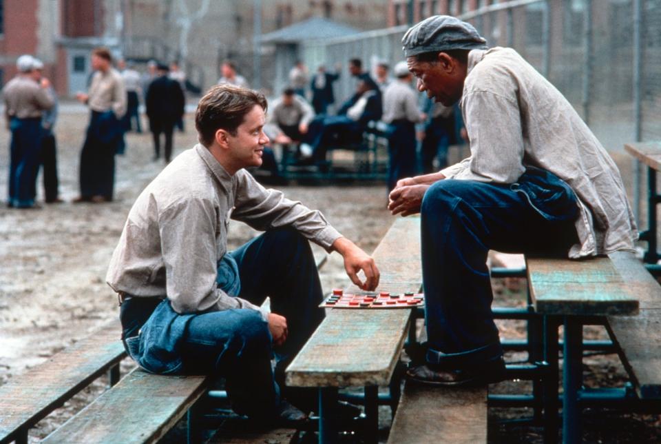 two men playing chess on a small set of bleachers