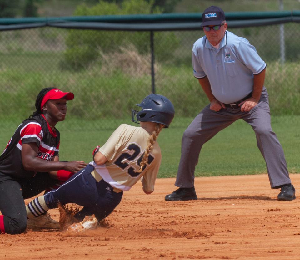 University Christian’s Macie Bourgholtzer (25) steals second base as Evangelical Christian’s Keaunna Green (13) tries to make the tag during the first inning.