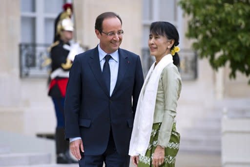 Myanmar pro-democracy leader Aung San Suu Kyi is welcomed by French President Francois Hollande at the Elysee presidential Palace in Paris, as part of her historic European tour