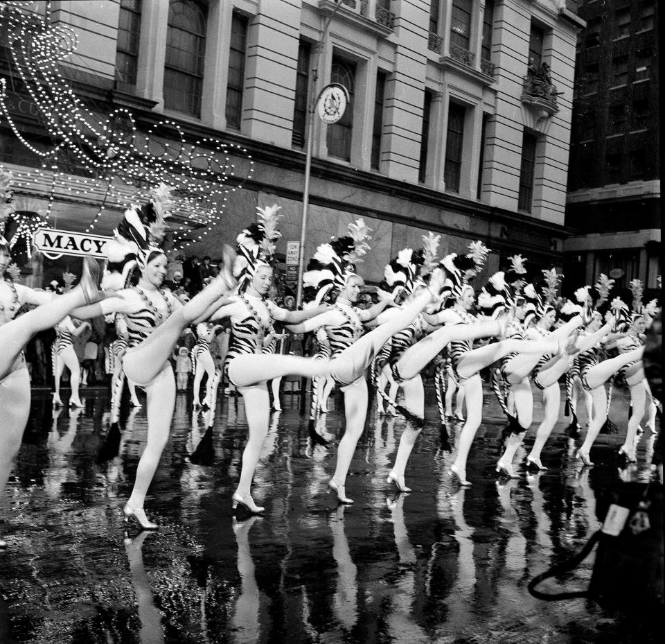 Members of the Radio City Music Hall Rockettes entertain crowds in front of rain-streaked Macy's department store, Nov. 25, 1971. The Rockettes were one of the many attractions of the 44th annual Macy's Thanksgiving Day Parade.