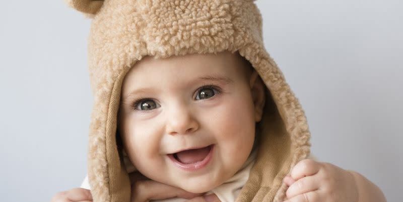 meaningful baby girl names  smiling baby being held up by adult