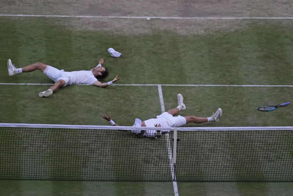 Matthew Ebden, left, and Max Purcell of Australia celebrate after beating Mate Pavic and Nikola Mektic of Croatia to win the final of the men's doubles on day thirteen of the Wimbledon tennis championships in London, Saturday, July 9, 2022. (AP Photo/Alastair Grant)