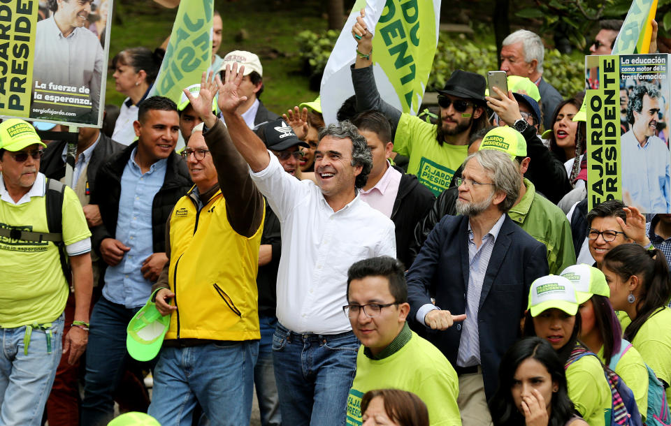 El candidato a la presidencia de Colombia Sergio Fajardo (c), de la centrista Coalición Colombia, saluda a sus seguidores junto a Antanas Mockus (c-d) y Jorge Robledo (c-i), en una caminata el 20 de mayo de 2018, en Bogotá (Colombia) (Foto EFE/Leonardo Muñoz).