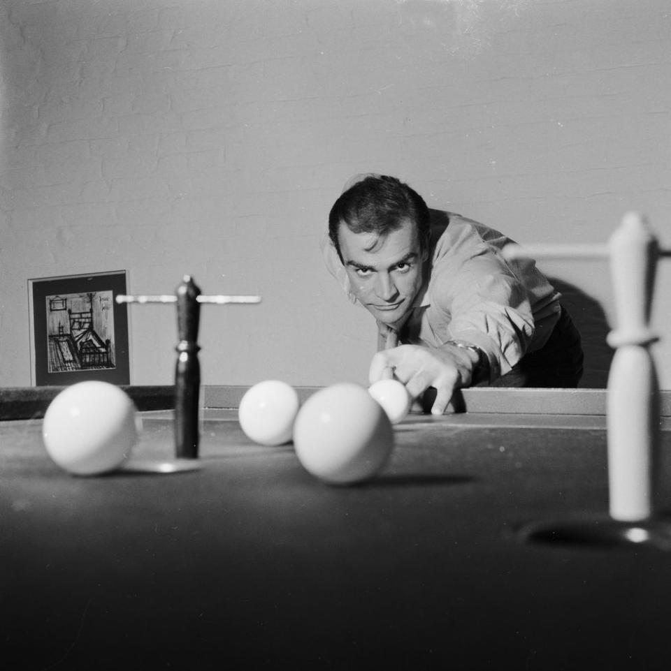 <p>Connery shoots some pool at his basement flat in London's NW8, 1962.</p>