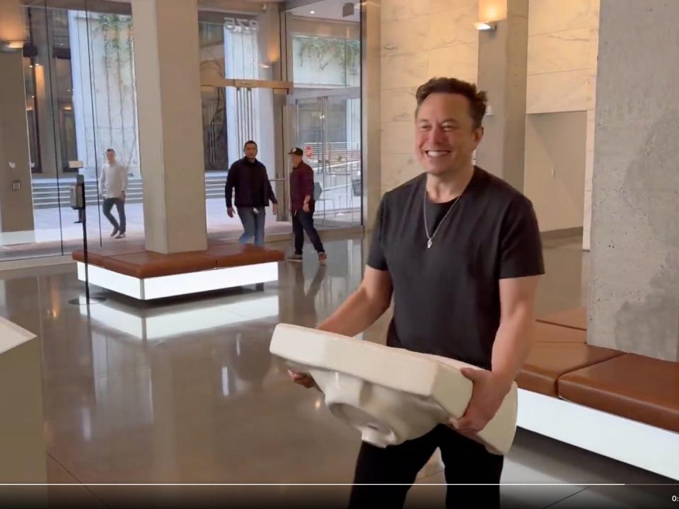 Elon Musk is shown carrying a sink into Twitter's headquarters in San Francisco
