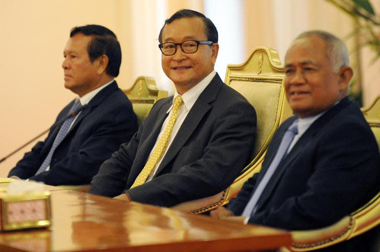 Cambodian opposition leader Sam Rainsy (C), deputy of Cambodia National Rescue Party (CNRP) Kem Sokha (L) and MP-elect Pol Hom (R) in Phnom Penh on July 22, 2014