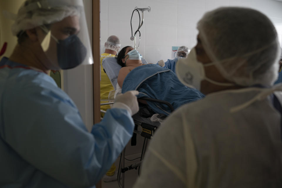 Medical workers move new coronavirus patient Rosane Pacheco to be treated at the Dr. Ernesto Che Guevara hospital in Marica, Brazil, Thursday, May 21, 2020. (AP Photo/Leo Correa)