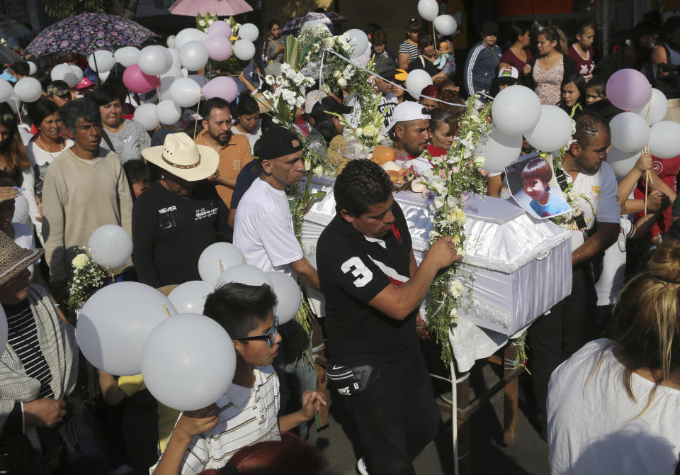 The casket of 7-year-old murder victim Fatima is taken from her home to a church for a funeral Mass in Mexico City, Tuesday, Feb. 18, 2020. The girl was taken from her school by a stranger on Feb. 11, and found dead four days later in a bag in a rural area. (AP Photo/Marco Ugarte)