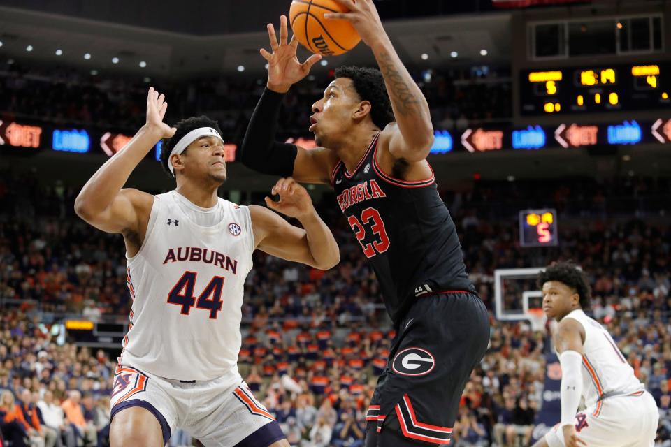 Jan 19, 2022; Auburn, Alabama, USA; Georgia Bulldogs guard Braelen Bridges (23) shoots over Auburn Tigers center Dylan Cardwell (44) during the first half at Auburn Arena. Mandatory Credit: John Reed-USA TODAY Sports