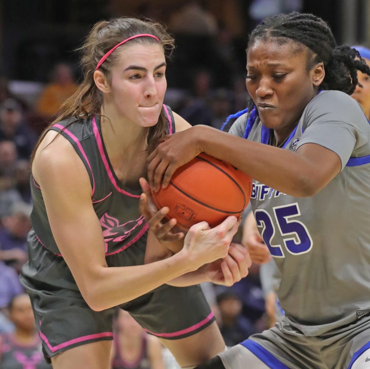 University of Akron forward Reagan Bass and Buffalo's Adebola Adeyeye battle for a rebound in a Mid American Conference semifinal Friday at Rocket Mortgage FieldHouse. The Bulls beat the Zips 82-43. [Phil Masturzo/Beacon Journal]