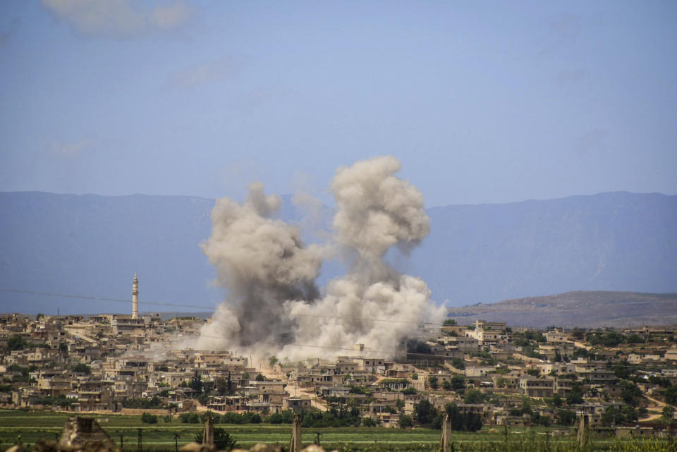 FILE - In this May 3, 2019 file photo, provided by the Syrian Civil Defense White Helmets, which has been authenticated based on its contents and other AP reporting, shows smoke rising after Syrian government and Russian airstrikes that hit the town of al-Habeet, southern Idlib, Syria. The violence raging once again in the northwestern province of Idlib, Syria's last rebel-held bastion, is putting Turkish-Russian relations to the test. (Syrian Civil Defense White Helmets via AP, File)