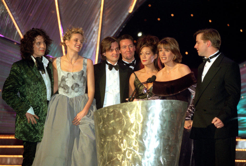 PA News 27/10/98 'Changing Rooms' presenter Carol Smillie (2nd from right), co-presenter Handy Andy (right) and the rest of the 'Changing Rooms' team receive the award for the Most Popular Factual Entertainment Programme arrives at the Royal Albert Hall in London for the National Television Awards.   (Photo by Ben Curtis - PA Images/PA Images via Getty Images)