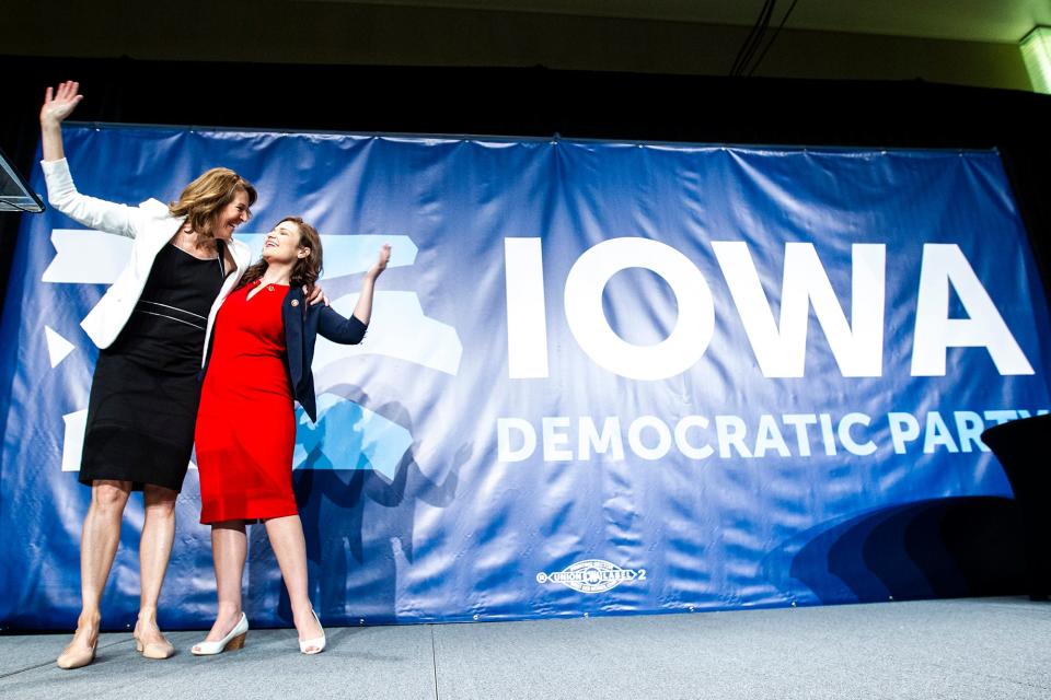 U.S. Reps. Cindy Axne, left, and Abby Finkenauer of Iowa wave while taking the stage during the Iowa Democratic Party Hall of Fame dinner, Sunday, June 9, 2019, at the DoubleTree by Hilton in Cedar Rapids, Iowa.