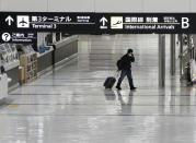 An international arrivals lobby is deserted at Narita International Airport in Narita, east of Tokyo, Japan, Monday, Nov. 29, 2021. Japan’s NHK national television said the country’s transport ministry on Wednesday, Dec. 1, requested international airlines to stop taking new reservations for all flights arriving in Japan until the end of December. (Miyuki Saito/Kyodo News via AP)