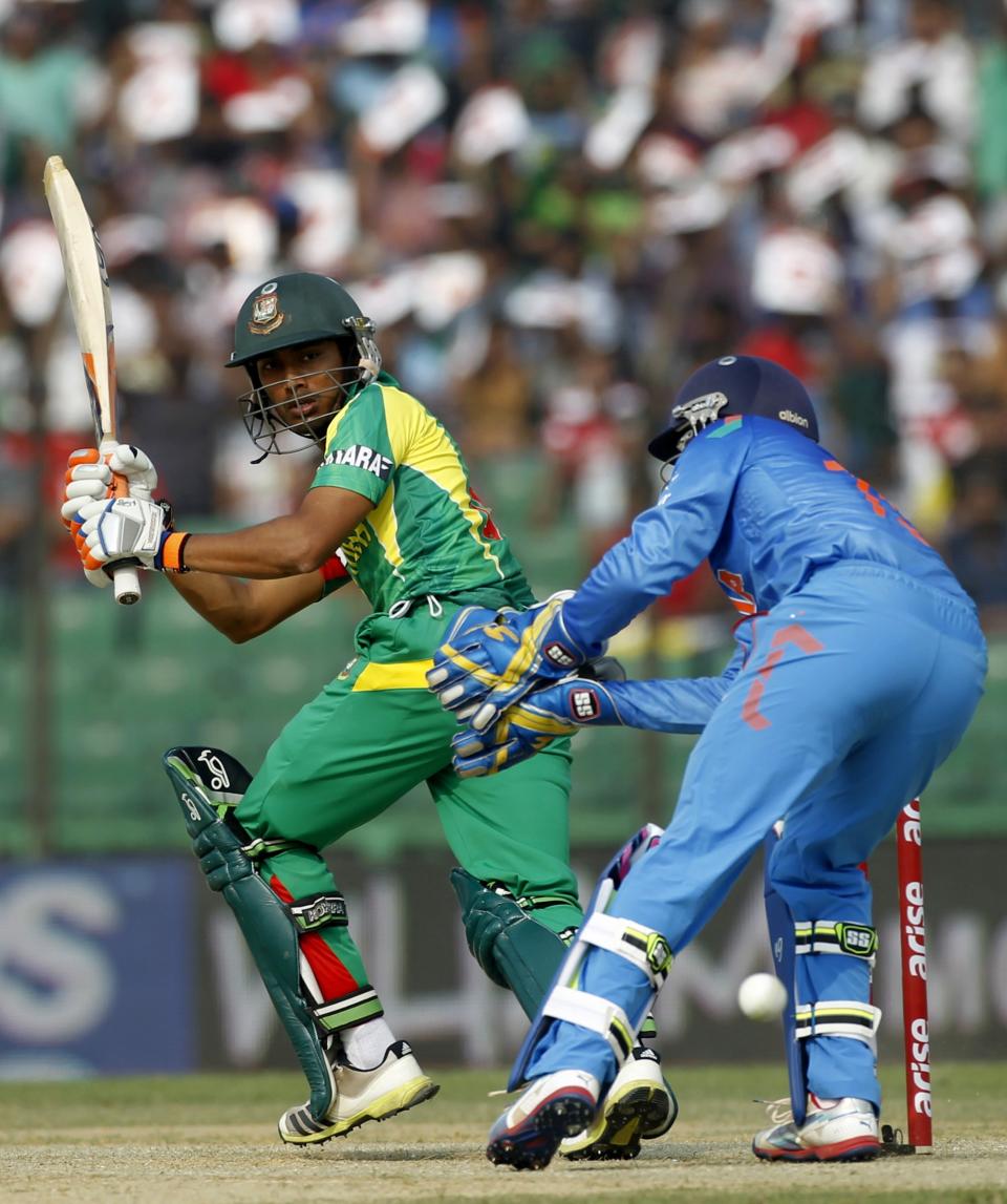 Bangladesh's Anamul Haque (L) plays the ball as India's wicketkeeper Dinesh Karthik tries to catch it during their Asia Cup 2014 one-day international (ODI) cricket match in Fatullah February 26, 2014.