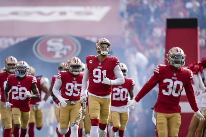 The San Francisco 49ers take the field for the start of a game against the Miami Dolphins.