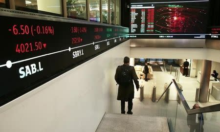 People walk through the lobby of the London Stock Exchange in London, Britain November 30, 2015. REUTERS/Suzanne Plunkett