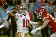 San Francisco 49ers' quarterback Jimmy Garoppolo passes under pressure from Kansas City Chiefs' Ben Niemann, right, during the second half of the NFL Super Bowl 54 football game Sunday, Feb. 2, 2020, in Miami Gardens, Fla. (AP Photo/Matt York)