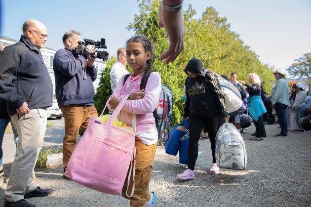 An underage migrant (center) is loaded onto a bus to be transported to Martha's Vineyard with dozens of other undocumented immigrants on Friday, Sept. 16. (Photo: Dominic Chavez for The Washington Post via Getty Images)