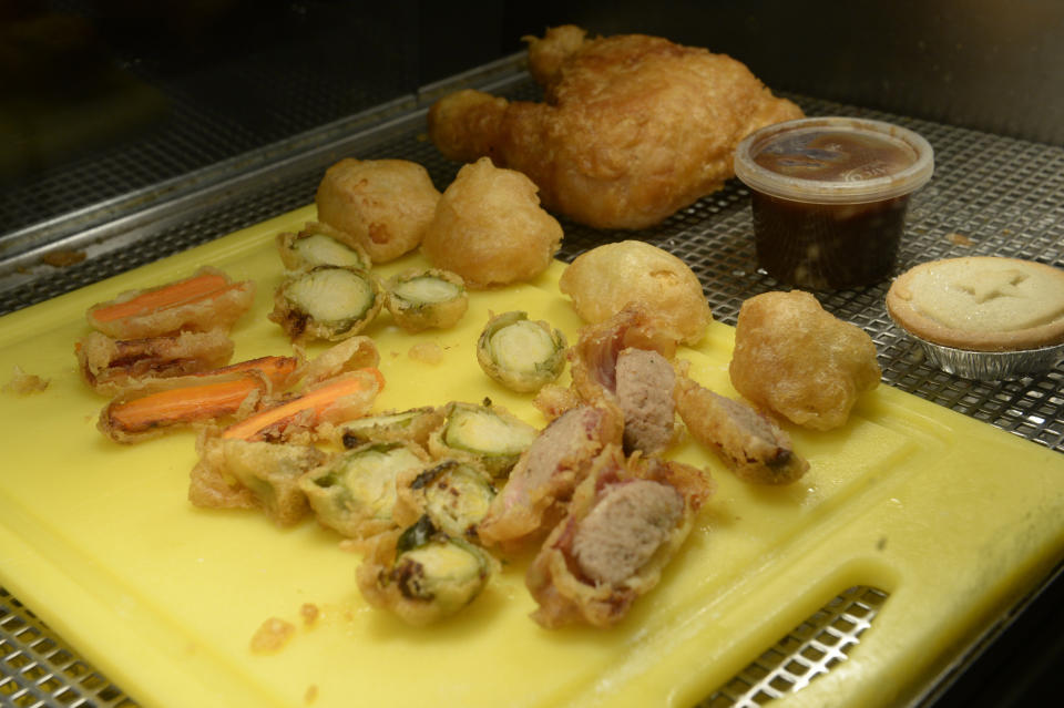 Inside the deep-fried Christmas dinner including chicken or turkey, sprouts, carrots, pigs in blankets and roast potatoes for £8. (SWNS)