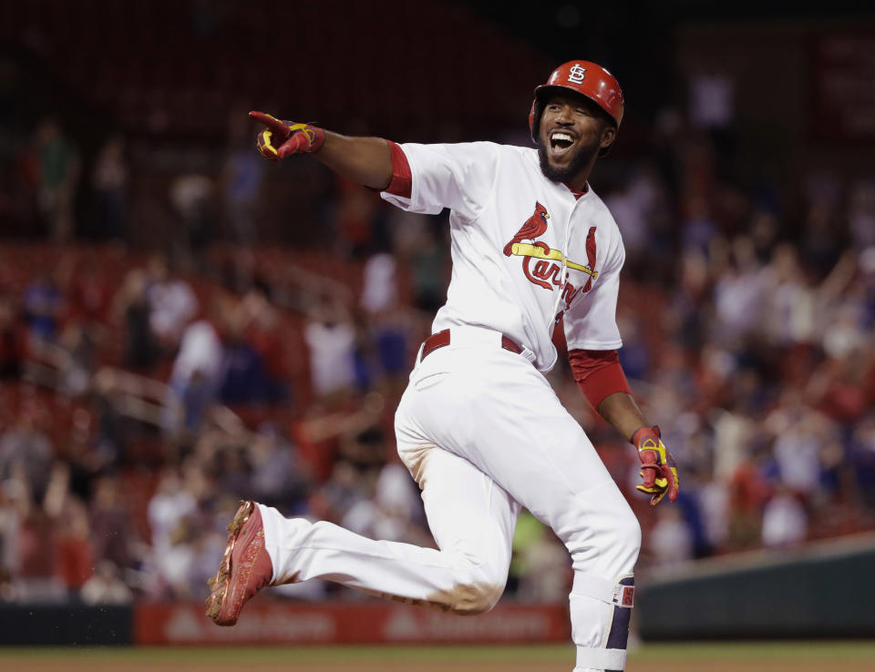 St. Louis Cardinals’ Dexter Fowler, right, looks back into the dugout and celebrates his walk-off two-run home run off Chicago Cubs relief pitcher Luke Farrell during the 14th inning of a baseball game Monday, May 7, 2018, in St. Louis. The Cardinals won 4-3. (AP Photo/Charles Rex Arbogast)